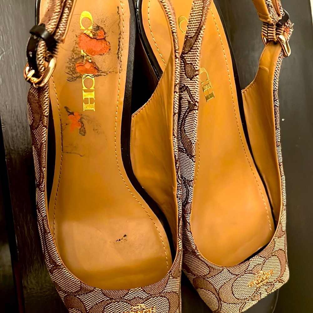 coach heels 8.5 women used little tear on top but hide when you wear it.